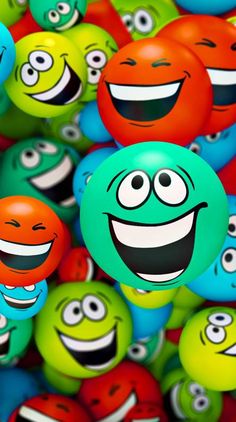 many different colored balls with faces on them