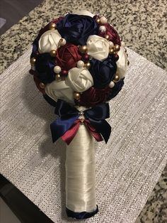 a bridal bouquet with pearls and satin ribbons on a lace tableclothed place mat