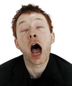 a man with his eyes closed and mouth wide open