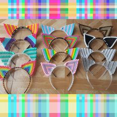 several cat ears made out of plastic beads on a wooden table with colorful plaid background