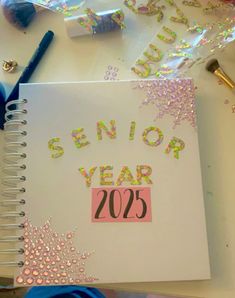 a notepad with the words senior year 205 on it next to some confetti