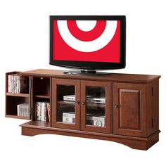 a flat screen tv sitting on top of a wooden cabinet