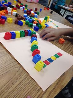 children are playing with legos on the table