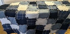 a blanket made out of old jeans on the floor