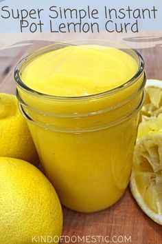 a glass jar filled with lemon curd next to sliced lemons