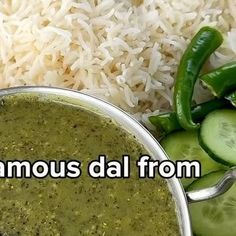 a bowl filled with green liquid next to rice and cucumbers