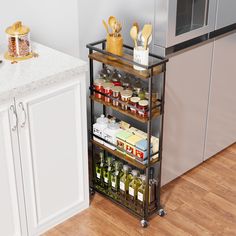 a kitchen with an oven, microwave and spice rack on the floor next to it