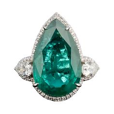 Make a statement in this stunning 9.37 carat pear shaped Zambian Emerald center stone cocktail ring, adorned with 0.62 carat pear shape Diamond side stones, and 0.22 carat round Diamonds. The Emerald is transparent, with a beautiful vivid green color and amazing luster. Whether worn for a special occasion or as an everyday statement piece, it's a work of art that will enchant and enchant for years to come. Currently sized at US 7, can be resized. Please feel free to message us for more informati Luxury Pear-shaped Emerald Ring, Columbian Emeralds, Zambian Emerald, Pear Shaped Diamond, Zambia, Cocktail Ring, Three Stone, Pear Shape, Cocktail Rings