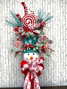 a snowman made out of candy canes and christmas decorations