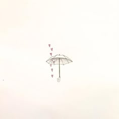 two umbrellas with hearts attached to them floating in the air