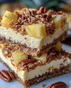 three pieces of dessert on a plate with pecans around the edges and one slice cut in half