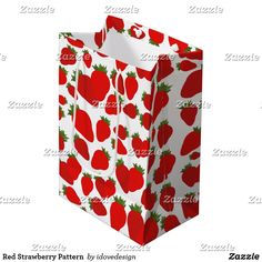 a paper bag with strawberries on it is sitting in front of a white background