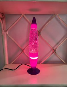 a pink lamp sitting on top of a table