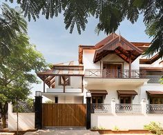 a large white house with wooden balconies