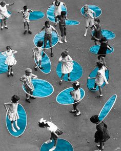 an aerial view of children playing on blue circles in the street with their arms outstretched