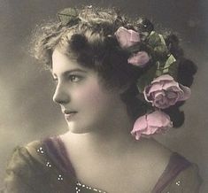 an old fashion photo of a woman with flowers in her hair, wearing a purple dress