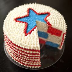 a cake with red, white and blue frosting on it that has a piece cut out