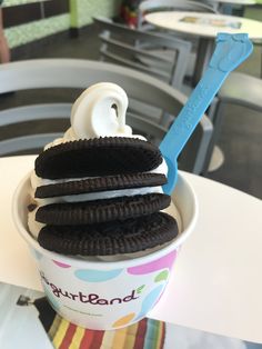 an ice cream sundae with oreo cookies and a toothbrush in the middle