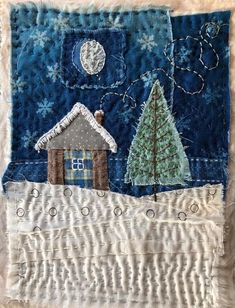 a piece of fabric with a house and trees on it in front of the moon