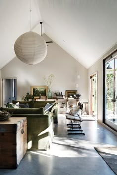 a living room filled with furniture and large windows