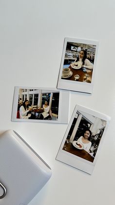 three polaroid photos sitting on top of a white table next to a computer mouse