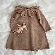 a knitted dress with a teddy bear on it