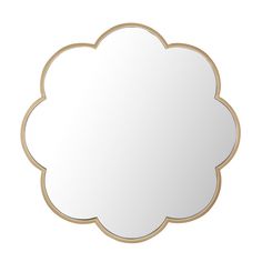 a white cloud shaped mirror sitting on top of a table