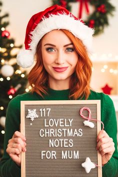 a woman wearing a santa hat holding a sign that says lovely christmas notes for mum