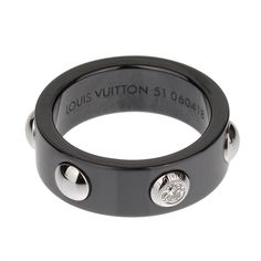 The Louis Vuitton Ceramic Platinum Diamond Band Ring is a stunning piece that seamlessly blends modern design with timeless elegance. This luxurious ring is crafted from high-quality materials, including black ceramic, platinum, and a brilliant diamond, making it a distinctive and sophisticated accessory. The band is made from sleek black ceramic, known for its durability and contemporary appeal. The ceramic's smooth, polished surface offers a modern and edgy look, providing a striking contrast to the platinum accents. The black ceramic not only adds to the ring's aesthetic appeal but also ensures that it is comfortable to wear and resistant to scratches and everyday wear. Adorning the ceramic band are platinum studs, each meticulously placed to create a balanced and symmetrical design. Th Louis Vuitton Necklace, Louis Vuitton Collection, Symmetrical Design, Diamond Band Ring, Louis Vuitton Jewelry, Sparkling Diamond, Louis Vuitton Accessories, Diamond Rings Bands, Diamond Band