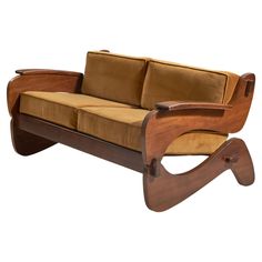 a brown and tan couch sitting on top of a wooden frame