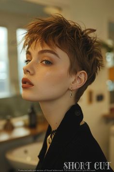 a woman with short hair standing in front of a sink and looking off to the side