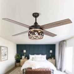 a ceiling fan in a bedroom with a bed and window behind it on the wall