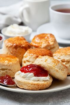 scones with jam and cream on a white plate