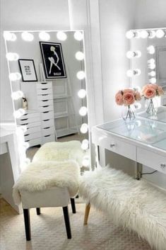 a white vanity with lights and stool in front of it