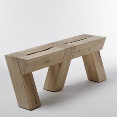 a wooden bench sitting on top of a white floor