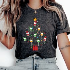 The Christmas Tree Wine tee is a classic jersey short sleeve t-shirt that fits like a well-loved favorite. Perfect for active and leisure this t-shirt makes a great Christmas gift for a wine lover or sommelier or funny holiday wine shirt. Soft cotton and quality print will make mom fall in love with it over and over again.  .: Crew neckline .: Made with 100% Airlume combed and ring-spun cotton .: Lightweight fabric that is breathable and easy to layer .: Sustainable manufacturing .: Ribbed knit collar with seam .: The tear-away label minimizes skin irritations. ---------------------- SHIPPING INFO ---------------------- Shipping time for your order is approximately 2-5 business days. Once shipped you'll receive tracking information from Etsy. ---------------------- PROPER SIZING ---------- Wine Ugly Christmas Sweater, Wine Christmas Tree, Christmas Wine Shirt, Wine Christmas, Mom Fall, Wine Shirt, Holiday Wine, Christmas Tree Shirt, Wine Shirts