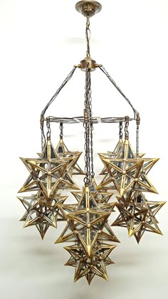 a chandelier made out of metal stars hanging from it's center point