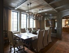 a large dining room table with chairs and chandelier