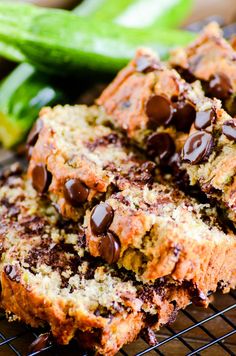 chocolate chip zucchini bread on a cooling rack with cucumbers in the background