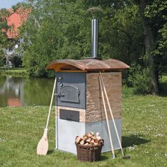 an outdoor wood burning oven in the grass