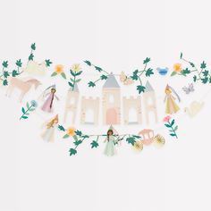 paper cut out of the shape of a castle with princesses and flowers on it