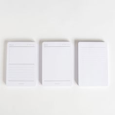 three blank notepads lined up on top of each other