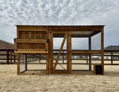 a chicken coop in the middle of an open field