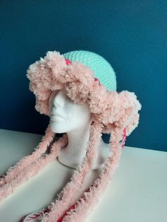 a white mannequin head wearing a pink hat