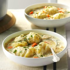 two bowls filled with soup on top of a table