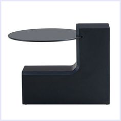 a black table with a glass top and curved base on the bottom, against a white background