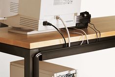 a computer sitting on top of a wooden desk