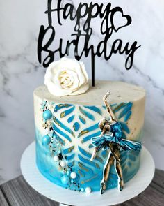 a blue and white birthday cake with a fairy on top that says, happy birthday