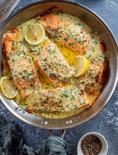 fish with lemons and herbs in a pan