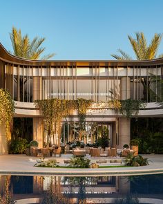 a large building with lots of windows next to a pool